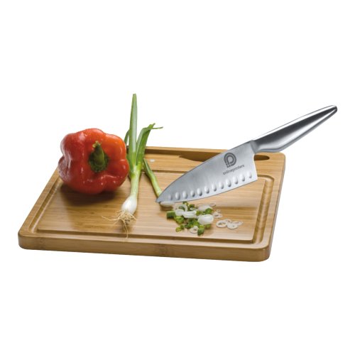 Wooden cutting board with knife and juice groove.