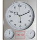 Silver plastic wall clock with thermometer and hygrometer.