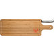 Light bamboo cutting board with juice groove and knife.